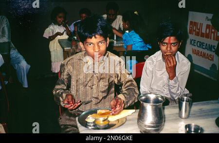 Varanasi India Boy eating Traditional Food off of Thali Plate Stock Photo