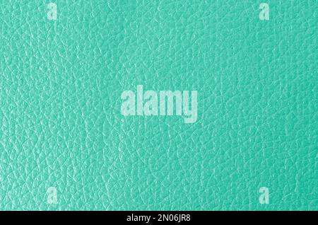 Texture of genuine grainy leather of light mint green color for wallpaper or banner design. Fashionable modern background, copy space Stock Photo