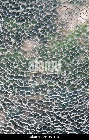 Shattered glass with green plants background Stock Photo