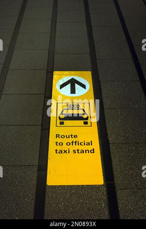 Direction to official taxi stand on the sidewalk of Schiphol International airport, the Netherlands Stock Photo