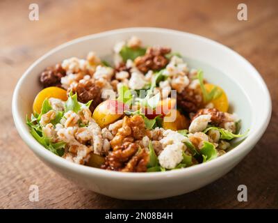 Farro Salad with Mirabelle Plums, Vegan Feta and Spicy Walnuts Stock Photo