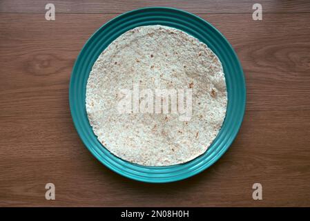 Wholegrain wraps on a green plate. Stock Photo