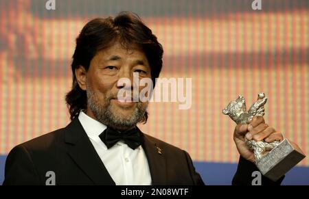 Mark Lee Ping-Bing, cameraman of 'Chang Jiang Tu' holds his Silver Bear for Outstanding Artistic Contribution during a press conference after the award ceremony of the 2016 Berlinale Film Festival in Berlin, Germany, Saturday, Feb. 20, 2016. (AP Photo/Markus Schreiber)