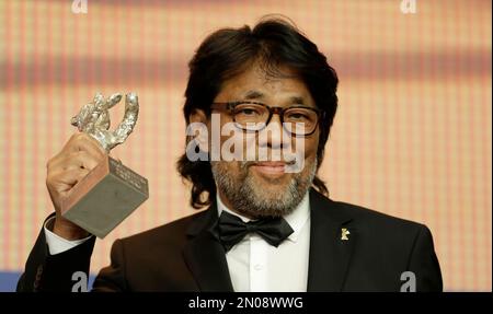 Mark Lee Ping-Bing, cameraman of 'Chang Jiang Tu' holds his Silver Bear for Outstanding Artistic Contribution during a press conference after the award ceremony of the 2016 Berlinale Film Festival in Berlin, Germany, Saturday, Feb. 20, 2016. (AP Photo/Markus Schreiber)