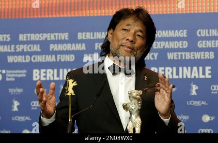 Mark Lee Ping-Bing, cameraman of 'Chang Jiang Tu' sits beside his Silver Bear for Outstanding Artistic Contribution during a press conference after the award ceremony of the 2016 Berlinale Film Festival in Berlin, Germany, Saturday, Feb. 20, 2016. (AP Photo/Markus Schreiber)