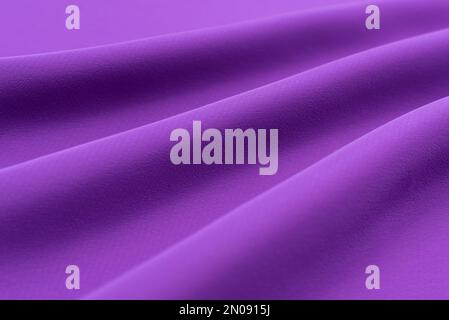 The texture of a luxurious smooth fabric in blue, purple with folds and waves. Blue fabric, material Stock Photo