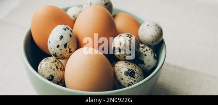 Easter eggs in the plate on beige background. Chicken and quail eggs catholic and orthodox easter holiday Stock Photo