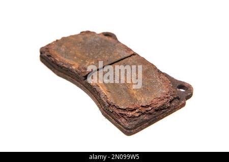 The old used and rusty disc brake pads isolated in a white background. Stock Photo