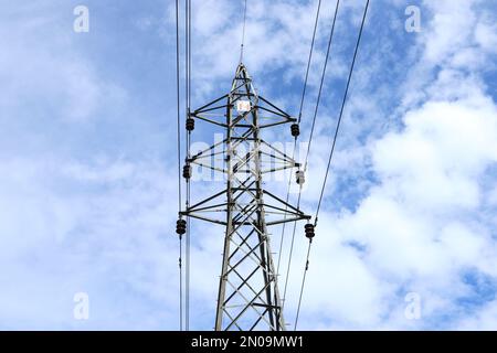 Low angle view of a high voltage electrical tower under the blue sky Stock Photo