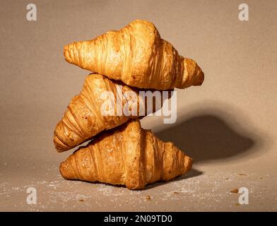 Fresh french croissants stack composition. Puff craft bakery on kraft paper. High quality photo Stock Photo