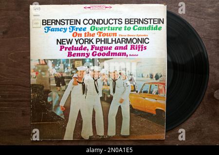 Lublin, Poland. 18 January 2023. Bernstein conducts Bernstein recordon dark wooden table Stock Photo