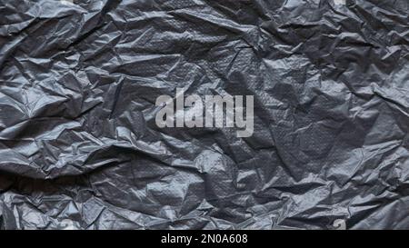 Black and crumpled plastic bag background and texture. Stock Photo