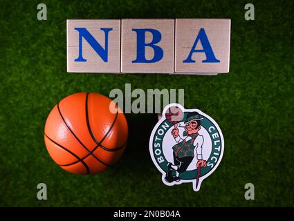 January 30, 2023, Springfield, USA. The emblem of the Boston Celtics National Basketball Association club on the green lawn of the stadium. Stock Photo