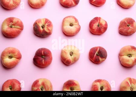 Fresh donut peaches on light pink background, flat lay Stock Photo