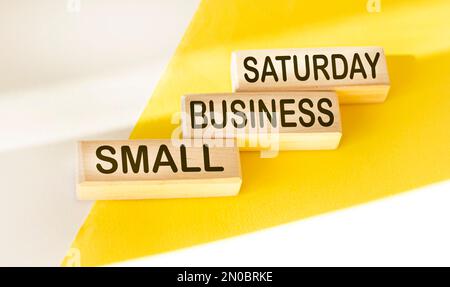 Abstract word small business saturday - text on wooden blocks and white and yellow background, holiday shopping concept Stock Photo