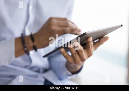 African gadget user man holding tablet computer, touching screen Stock Photo