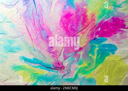 Texture created with napkin paper wet with multicolored liquid watercolors creating a gradient and rainbow effect Stock Photo
