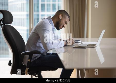 Cheerful young adult business man studying new skills Stock Photo