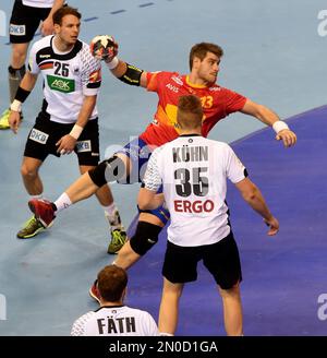 Spain's Julen Aguinagalde throws the ball between Germany's Kai Haefner , left, and Germany's Julius Kuehn , right, during the handball European Championships final between Germany and Spain in Krakow, Poland, Sunday, Jan. 31, 2016. (AP Photo/Alik Keplicz)