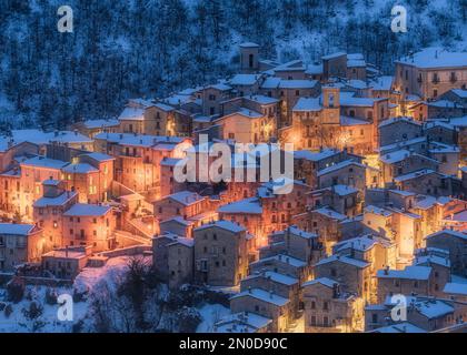 The beautiful Scanno covered in snow during a cold winter evening. Abruzzo, central Italy. Stock Photo