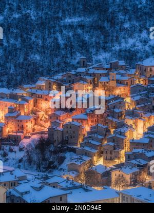 The beautiful Scanno covered in snow during a cold winter evening. Abruzzo, central Italy. Stock Photo