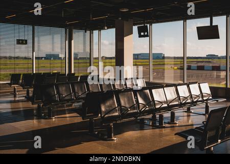 empty airport lounge with runway view windows - Stock Photo