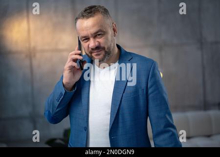 Portrait of a handsome young businessman talking on the phone Stock Photo