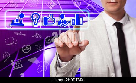 Business plan. Man pointing at virtual screen with different icons, closeup Stock Photo