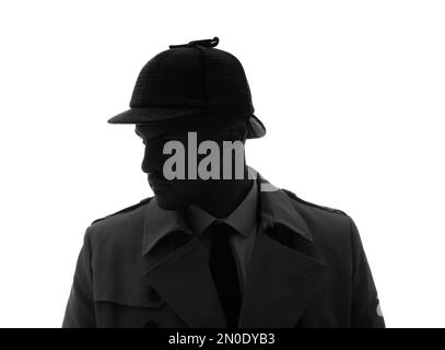Old fashioned detective in hat on dark background, black and white ...