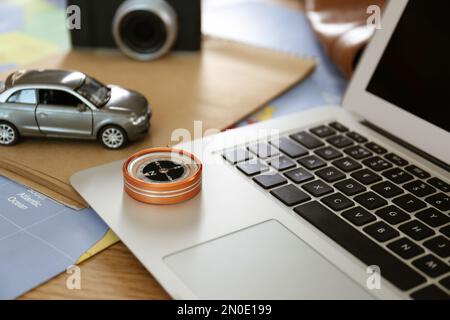 Composition with laptop and different items on world map. Trip planning Stock Photo