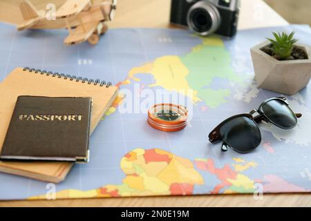 Composition with world map and different items on table. Trip planning Stock Photo