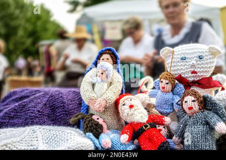 Crochet dolls made by elderly people for sale due to downsizing at a street stall. Stock Photo