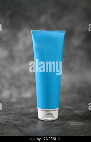 Blue bottle for cosmetics shower gel on a gray background Stock Photo