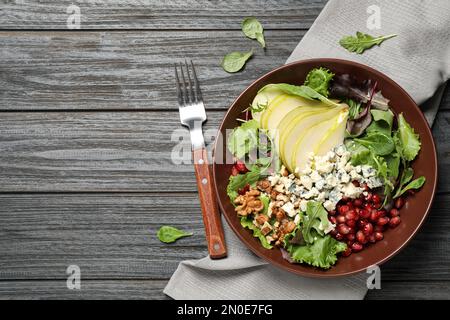 Tasty salad with pear slices served on black wooden table, flat lay. Space for text Stock Photo