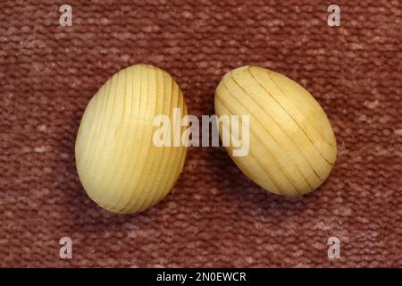 Easter wooden eggs, blanks for decor, painted close-up on a plain linen background front view Stock Photo