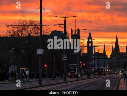 Edinburgh, Scotland, UK, 5th February 2023. UK Weather dramatic colourful fiery sunset sky.The sunset turned the sky vivid orange colours viewed over buses in Princes Street. Credit: Sally Anderson/Alamy Live News Stock Photo