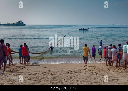 Traditional people Seine fishing in blue ocean on a sunny day in Sri Lanka, Galle 2022.12.05 Stock Photo
