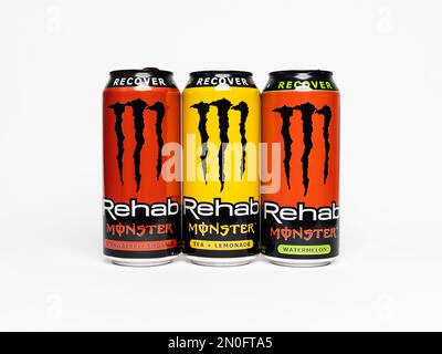 Monster Rehab beverage in the flavors strawberry, tea lemonade and watermelon. 3 American Monster energy recovery drink cans in a studio environment. Stock Photo