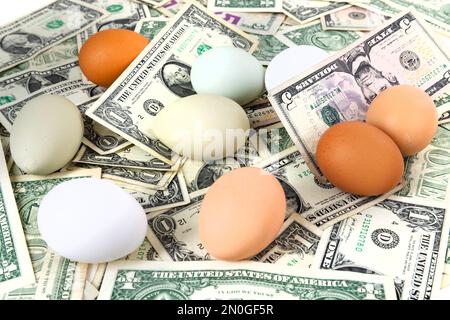 Close up eggs nested in a pile of ones and fives Stock Photo