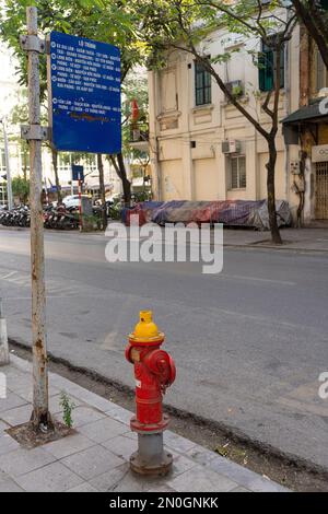 Hanoi, Vietnam, January 2023.  a bus stop sign and a fire hydrant on a downtown street Stock Photo