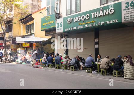 Hanoi, Vietnam, January 2023. a traditional open-air sidewalk restaurant in the city centre Stock Photo