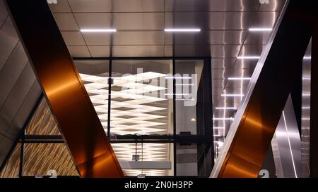 Combination of metal and glass wall material. Steel facade on columns. Abstract modern architecture. High-tech minimalist office building. Stock Photo