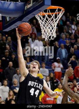 Butler center Andrew Smith (44) puts up a go-ahead score against Pittsburgh  guard Ashton Gibbs (12) with only seconds remaining in a third-round game  of the 2011 NCAA Men's Basketball Championship tournament
