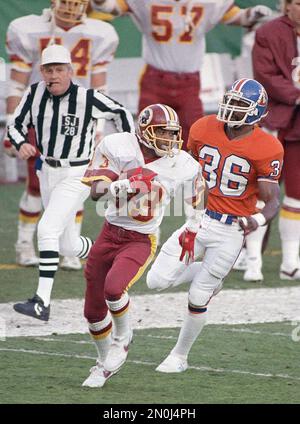 FILE - In this Jan. 31, 1988, file photo, Washington Redskins wide receiver Ricky  Sanders (83) is followed by Denver Broncos cornerback mark Haynes (36) as  he goes into the end zone