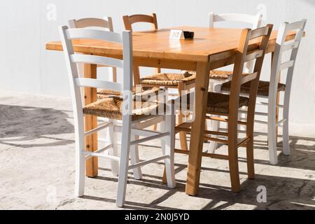 Wooden furniture, table and chairs in a street restaurant Stock Photo