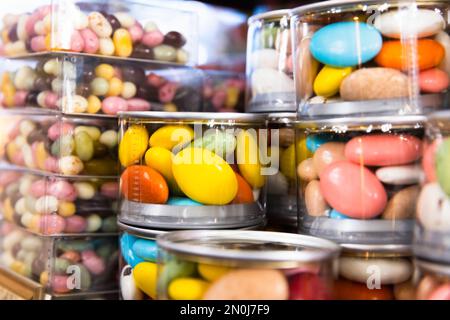 Candies dragee are in transparent plastic jars on a checkout counter in a candy shop Stock Photo