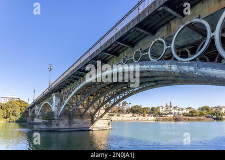 View of the Isabel II Bridge, popularly known as Puente de Triana, is a bridge located in Seville. It joins the city center with the Triana neighborho Stock Photo