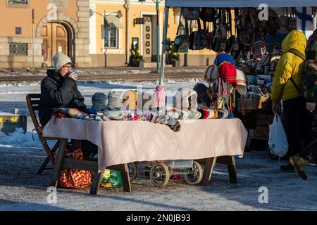 Market square vendor selling woolen socks, beanies and mittens in Helsinki, Finland Stock Photo