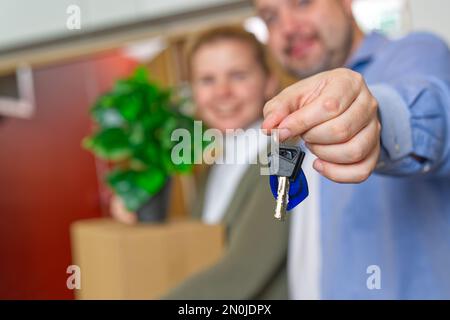 Couple showing keys to new apartment. real estate mortgage, loan concept. moving in new house Stock Photo