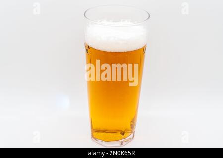 Pint of cold lager beer in a glass isolated on a whiite background Stock Photo